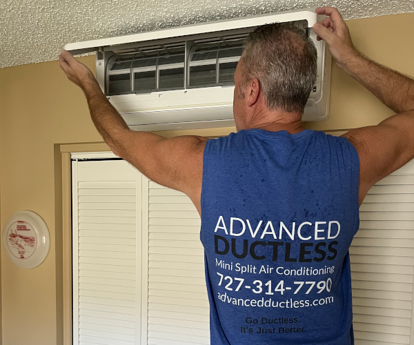 Advanced Ductless owner, Joe 'Ductless,' performing annual maintenance on a mini split AC system in Tampa Bay, Florida. Ensuring peak efficiency and long-lasting performance, this routine service helps maintain optimal cooling and energy savings.